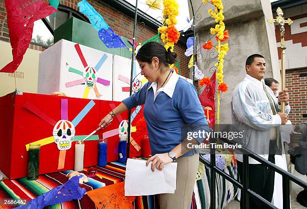 Alexandra Macias participates in the "lighting the light of the dead" at the alter during the Dia de los Muertos celebration October 31, 2003 at the...