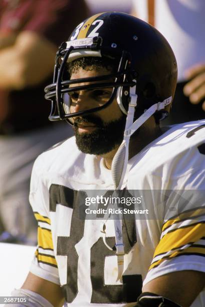 Franco Harris of the Pittsburgh Steelers sits on the sideline during a 1983 NFL season game.