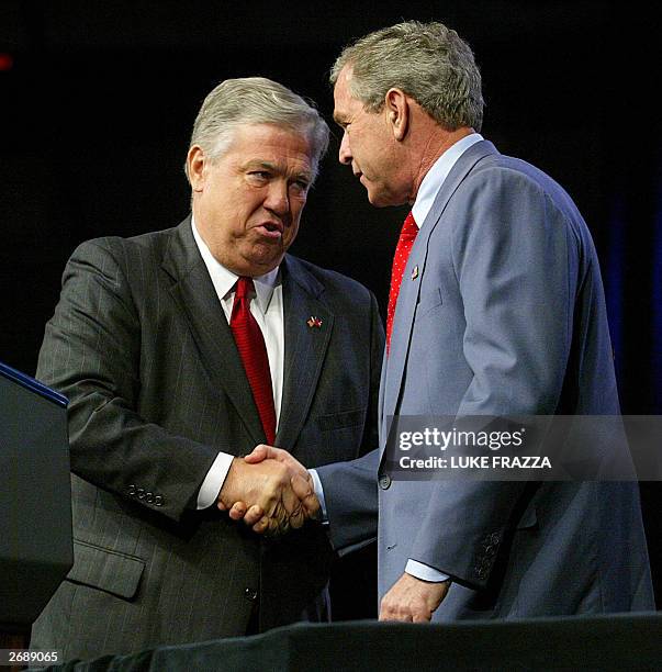 President George W. Bush attends a rally 01 November 2003 at the DeSoto Civic Center in Southaven, Mississippi with Haley Barbour , the Republican...