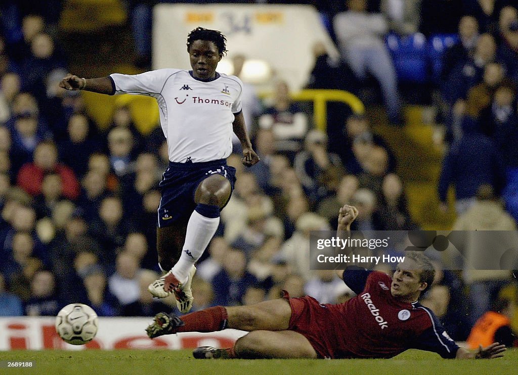 Kevin Davies of Bolton tries to tackle Mbulelo Mabizela of Tottenham Hotspur
