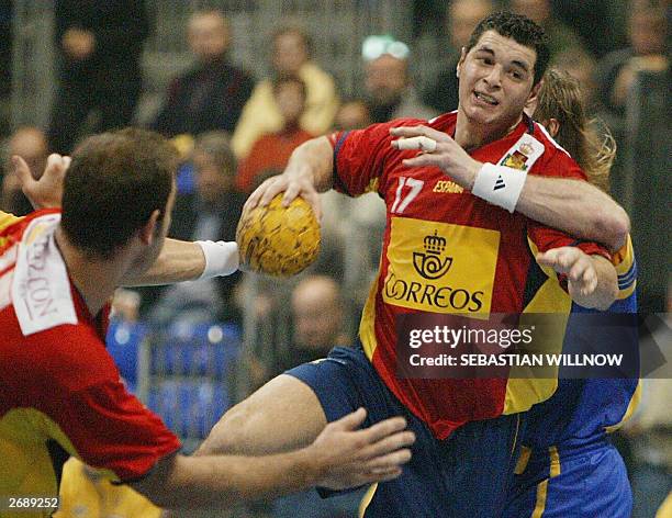 Spain's Alberto Entrerrios Rodriguez plays the ball as his teammate Manuel Colon Rodriguez stands aside during the Handball Supercup semi-final match...