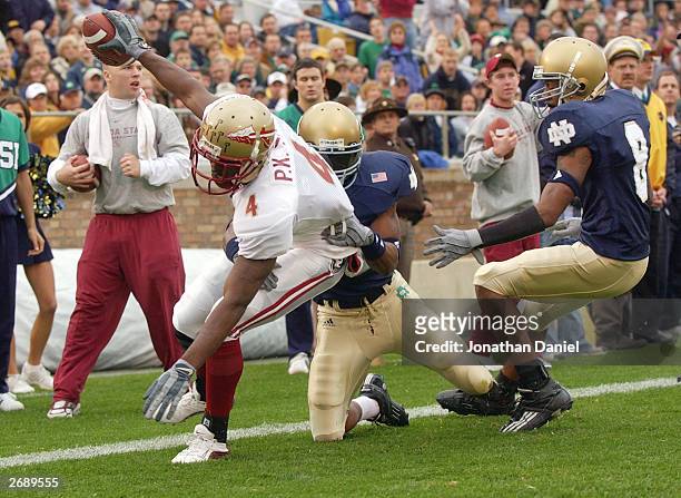 Receiver P.K. Sam of Florida State makes a touchdown catch under pressure from cornerback Dwight Ellick of Notre Dame during a game on November 1,...