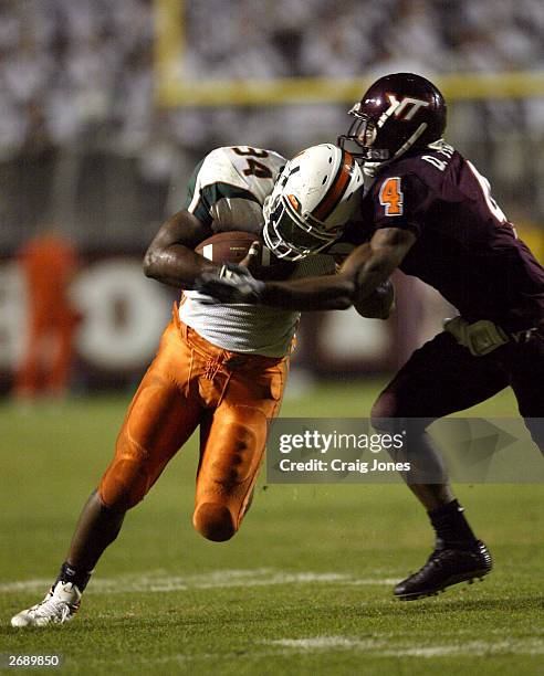 Jarrett Payton of the Miami Hurricanes tries to get rush by DeAngelo Hall of the Virginia Tech Hokies November 1 , 2003 at Lane Stadiumin Blacksburg,...