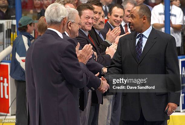 Grant Fuhr 2003 Hockey Hall of Fame inductee, shakes the hands of former HHOF inducties as he is introduced before the game between the Toronto Maple...