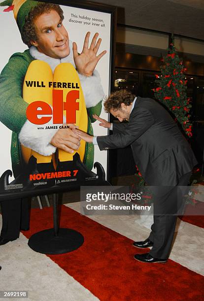 Todd Komarnicki, producer of Elf bows before a poster of his movie at a special screening of Elf to benefit the TJ Martell Foundation at Loews Astor...
