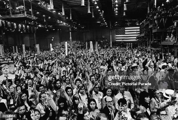 Large crowd of people on the convention floor gives the victory sign during the nomination of Senator George McGovern for president at the Democratic...