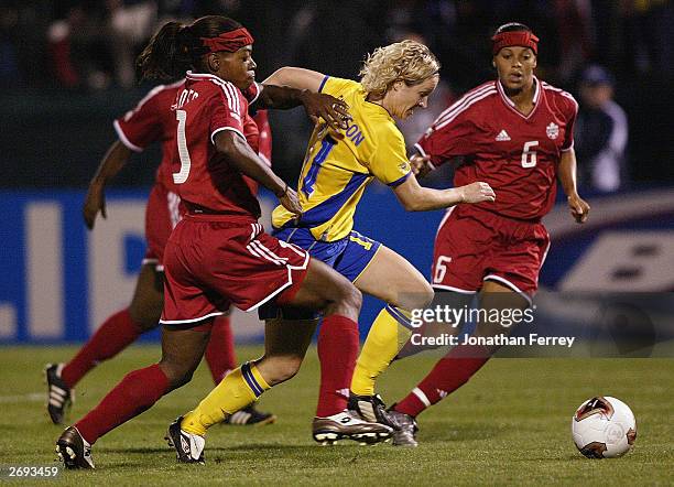 Forward Victoria Svensson of Sweden dribbles past forward Charmaine Hooper of Canada during the semifinals of the 2003 FIFA Women's World Cup match...