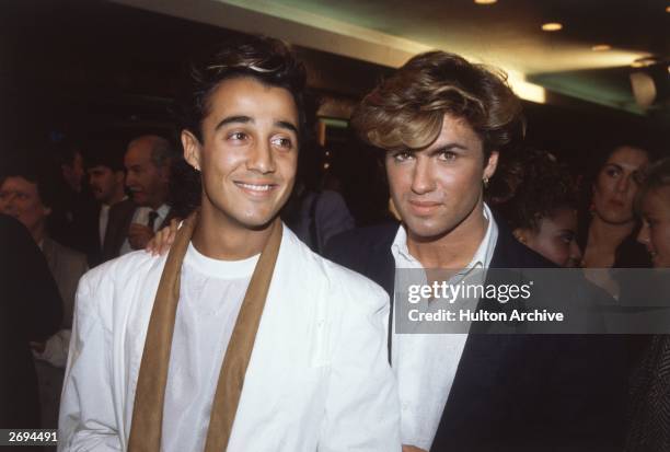 English pop stars Andrew Ridgeley and George Michael of Wham at the film premiere of 'Dune'.