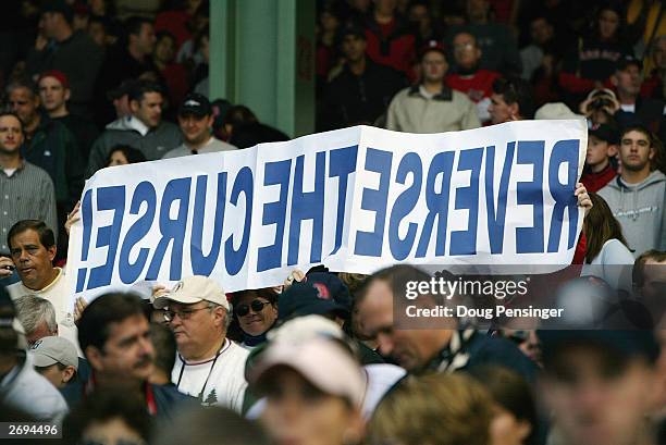 Boston Red Sox fans hold up a sign reading "Reverse the Curse" during game four of the American League Division Series against the Oakland Athletics...