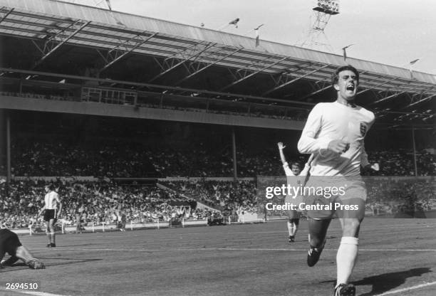 Footballer Geoff Hurst runs away in jubilation after scoring England's winning goal against Argentina at Wembley Stadium, London.