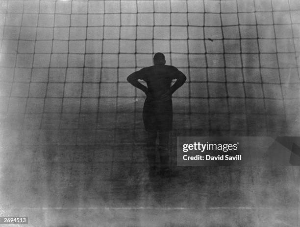 Pearson, the Millwall goalkeeper, peering into the fog during a semi-final of the London Challenge Cup against Arsenal at the Den.