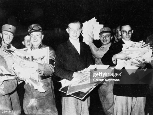 Group of Nazi troops and students gather seized papers and books to burn, in the Opernplatz, Berlin.