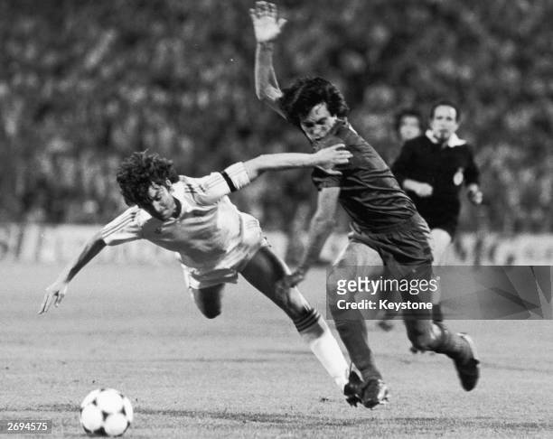 Referee Garcia Carrion watches as Jose Antonio Camacho of Real Madrid is tackled by Francisco Carrasco of Barcelona during the Spanish Cup final.