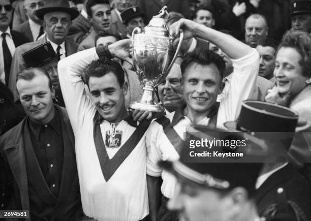 Two members of OSC Lille football team parade with their trophy after beating Bordeaux in the French Cup final.