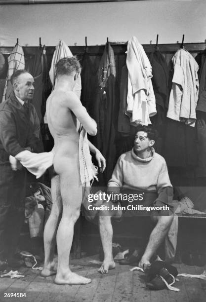 Manchester City trainer Laurie Barnett in the team's dressing room with players W Walsh and S W Evans. Original Publication: Picture Post - 5212 -...