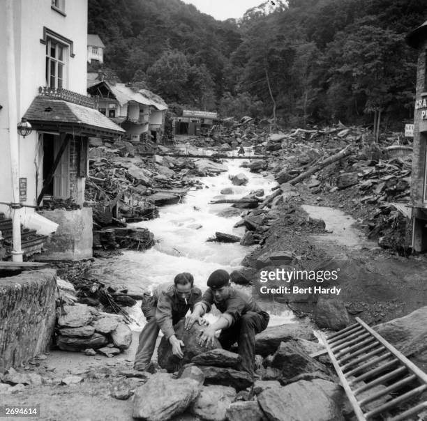 Troops clearing rocks in the devastated village of Lynmouth, Devon, following a flood which destroyed many of the houses and left several villagers...