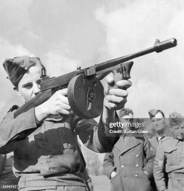 Home Guardsman handles a Tommy gun during a training session at the War Office School in Surrey. Original Publication: Picture Post - 295 - The Home...