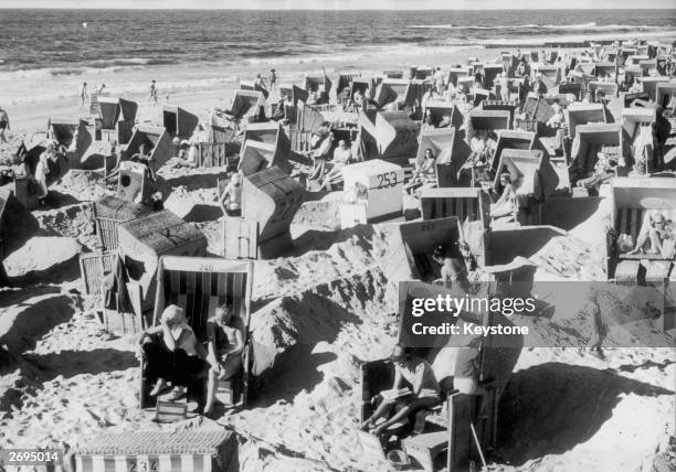 German holidaymakers sunbathing at a beach on the island of Sylt in Germany.