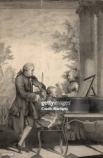 German composer Leopold Mozart playing the violin accompanied by his seven year old son Wolfgang Amadeus Mozart on the harpsichord, while his...