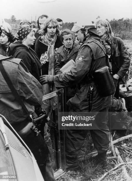 German police officer faces anti-nuclear waste demonstrators at a borehole in Gorleben, West Germany.