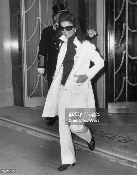 Jackie Onassis , widow of American President John F Kennedy and wife of Greek born Argentinian ship owner Aristotle Onassis, leaving Claridges Hotel...