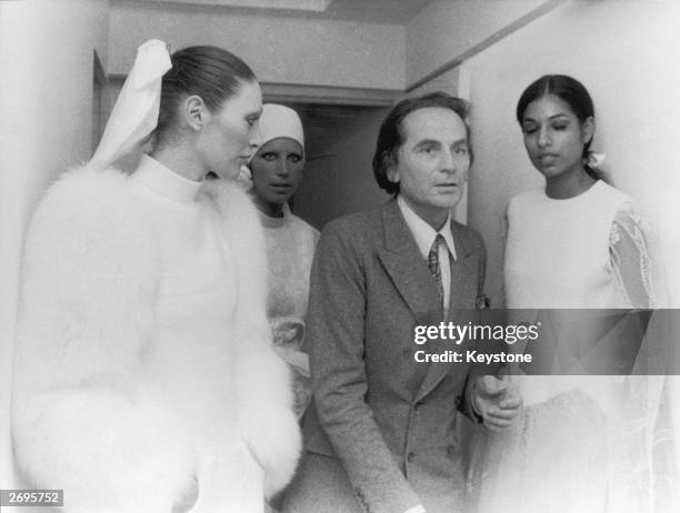 Couturier Pierre Cardin waits with models at his autumn/winter fashion show.