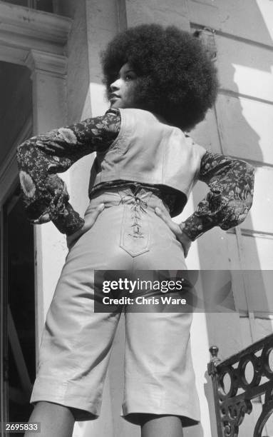 American funk soul diva Marsha Hunt wearing a knee-length leather two-piece suit with a laced up bolero at a skins and furs fashion show at the House...