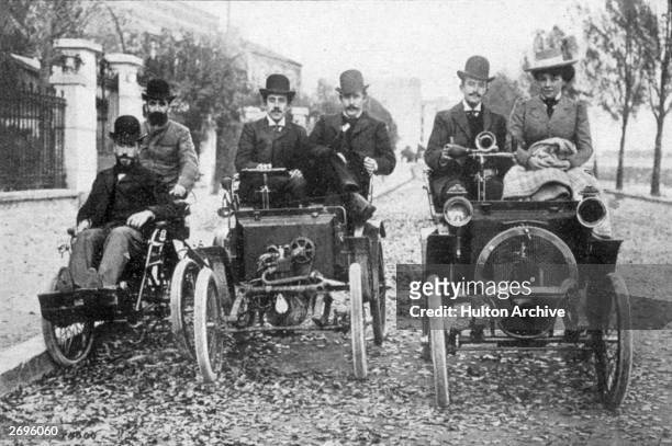 Marcel Renault on a 1898 quadricycle, with his brother Louis at the wheel of the 1998 voiturette and Paul Huge at the wheel of the prototype 1899...
