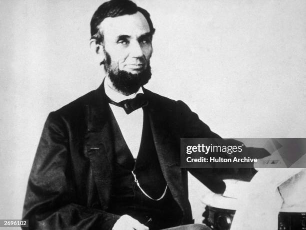 The 16th American president, Abraham Lincoln , sitting and leafing through documents, Washington, D.C.
