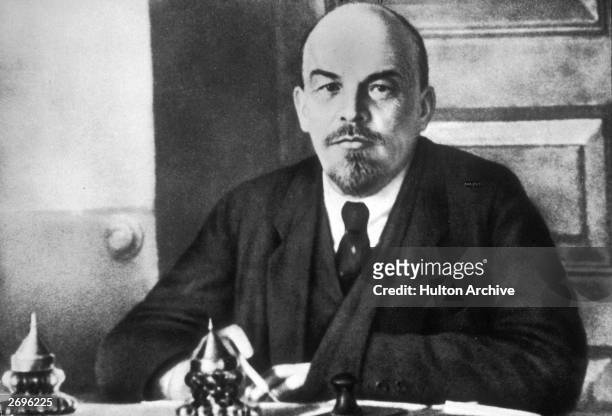 Portrait of Russian revolutionary leader Vladimir Lenin sitting at a table during a meeting of the Sovnarkom. Lenin founded the Bolshevik party.