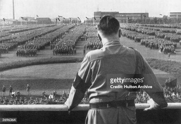 German Fuhrer and Nazi leader Adolf Hitler addresses soldiers with his back facing the camera at a Nazi rally in Dortmund, Germany.