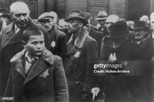 Jewish deportees, with the yellow stars sewn on their coats, arrive at Auschwitz concentration camp.