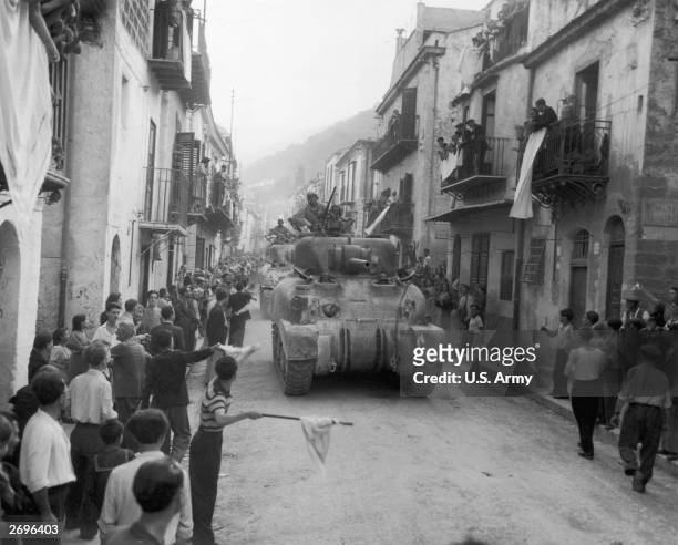 Residents of Palermo, Sicily, line the streets to greet the American Sherman tanks after the town had surrendered to the Allies.