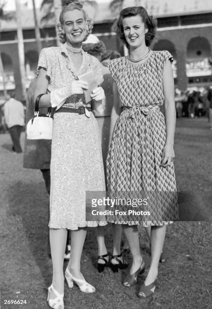 At Hialeah racetrack, Florida, members of the Social Register Mrs John A Morris from New York and Mrs Edward W C Russell of Washingrton DC. . They...