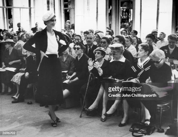 Spectators at a Dior fashion show in Paris, France. Centre front: Marie Louise Bousquet, Paris Editor of Harper's Bazaar and Carmel Snow, Editor in...