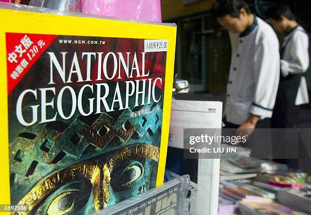 The Chinese edition of the famous US magazine National Geographic is displayed as local residents read books at a newsstand in Shanghai, 04 November...