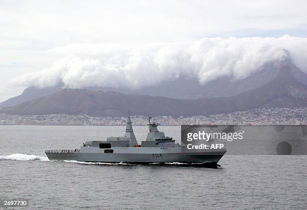 The naval corvette SAS Amatola sails past central Cape Town with its landmark Table Mountain covered with cloud on its way to the the naval base in...