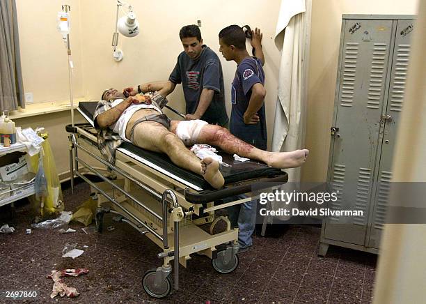 Samer Abu Assar, a 27-year-old Palestinian from Balata refugee camp, lies wounded in Rafidiya hospital November 4, 2003 in the West Bank town of...