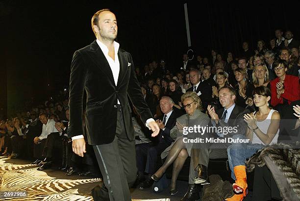 Designer Tom Ford acknowledges applause during Yves Saint Laurent Rive Gauche's spring/summer 2004 ready-to-wear collection on October 12, 2003 in...