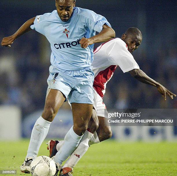 Celta's Brazilian Vagner gets ready to kick and score a goal under pressure of Ajax's Ghanaian Abubakari Yakubu during Champion's League match...