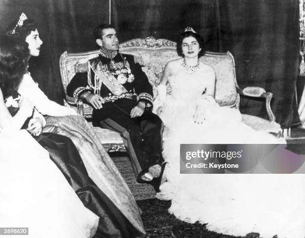 Muhammad Reza Pahlavi, the Shah of Iran with his second wife Princess Soraya Esfandiary Bakhtiari after their wedding ceremony. His sisters who acted...