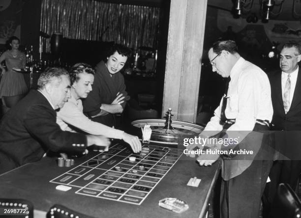 Italian born American opera singer, Marguerite Piazza, watching guests play roulette at the Sands Hotel in Las Vegas.