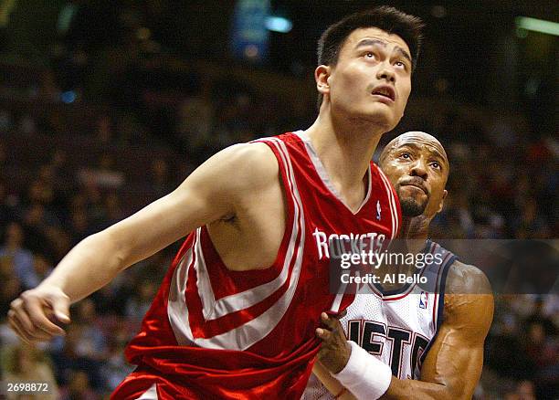 Alonzo Mourning of the New Jersey Nets battles for position against Yao Ming of the Houston Rockets November 4, 2003 at the Continental Airlines...