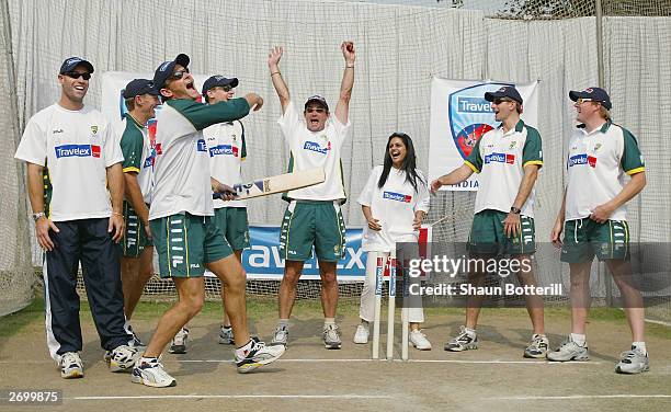 Adam Gilchrist and team-mates Michael Bevan, Andy Bichel, Nathan Bracken, Jimmy Maher, Michael Kasprowicz and Brad Williams of Australia with Indian...