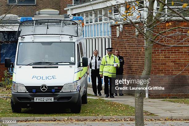 Police emerge from Birkbeck School and Community Arts College on November 5, 2003 in North Somercotes, Lincolnshire, England. Pupil Luke Walmsley 14,...