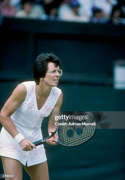 Billie Jean King stands on the court during a match at Wimbledon in England.