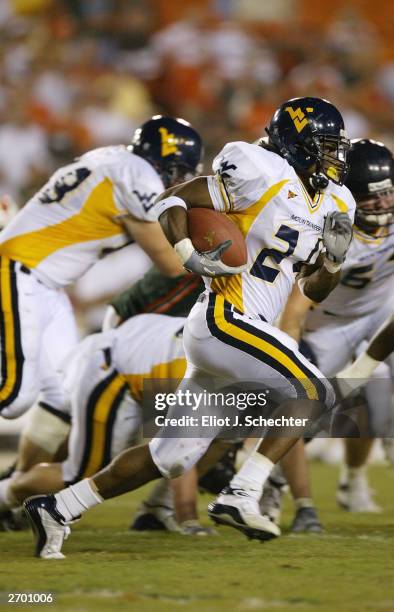 Running back Jason Colson of the West Virgina Mountaineers runs for a first down against the University of Miami Hurricanes on October 2, 2003 at The...