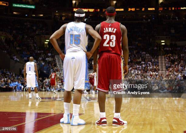 LeBron James of the Cleveland Cavaliers and Carmelo Anthony of the Denver Nuggets wait for play to start back up November 5, 2003 at Gund Arena in...