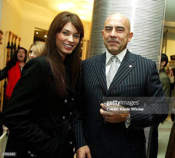 Model Cinthia Moura and Ferre CEO Enrico Mambelli pose at a party held at Ferre Rodeo Store on November 5, 2003 in Beverly Hills, California.