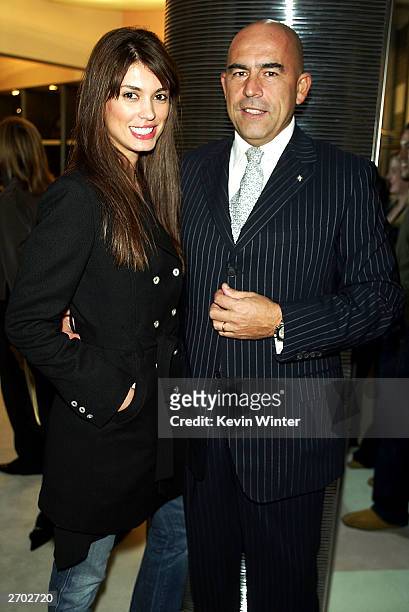 Model Cinthia Moura and Ferre CEO Enrico Mambelli pose at a party held at Ferre Rodeo Store on November 5, 2003 in Beverly Hills, California.